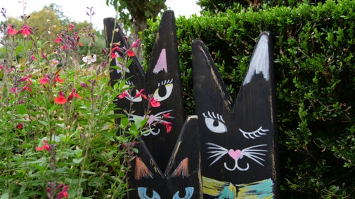 Model cats in the garden at Baddesley Clinton, Warwickshire